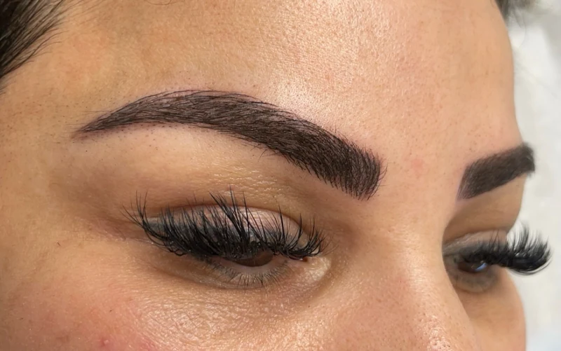 Close-up of eyebrow work by The Polished Brow, showing the brow arches and individual strokes.